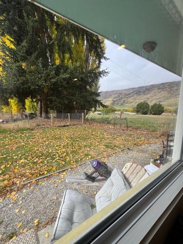 a view from a window of a couch in a yard at Stay Cardrona Wanaka in Cardrona