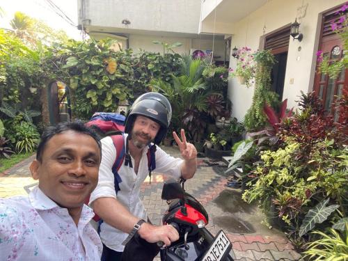 a man with a helmet on top of a motorcycle at JJ Villa & Tours in Aluthgama
