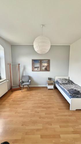 a room with a bed and a chair in it at Etage1 in Hameln