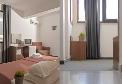 a bedroom with a bed and a chair and a desk at Sea house Afrodita1-rooms in Nesebar