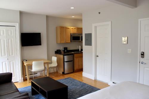 a room with a kitchen and a living room at Stylish Downtown Studio in the South End, #8 in Boston