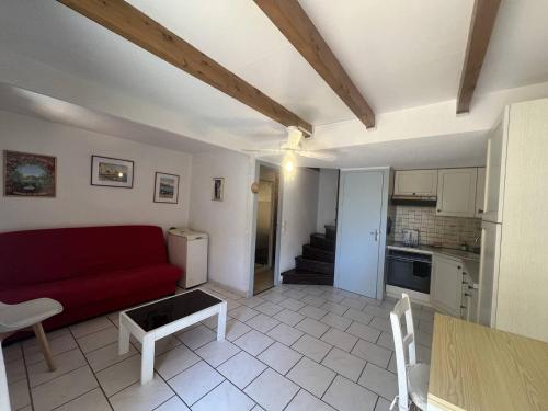 un salon avec un canapé rouge et une cuisine dans l'établissement Villa 5 pers, Mezzanine, WIFI, Clim, Parking, près Plage - FR-1-81-632, au Barcarès