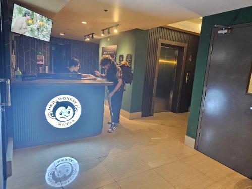 a woman standing at a counter in a restaurant at Mad Monkey Manila in Manila