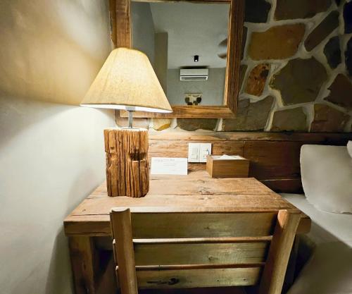 a wooden table with a lamp and a mirror at Victory Hotel in Hue
