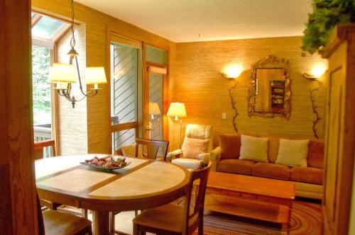 a living room with a table and a couch at Snowater Condo 84 - large condo with private sauna and soaker tub in Bellingham