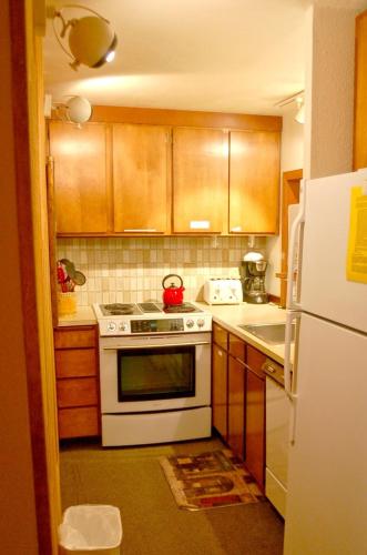 a kitchen with a white stove and a white refrigerator at Snowater Condo 84 - large condo with private sauna and soaker tub in Bellingham