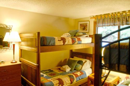 two bunk beds in a room with a lamp at Snowater Condo 84 - large condo with private sauna and soaker tub in Bellingham