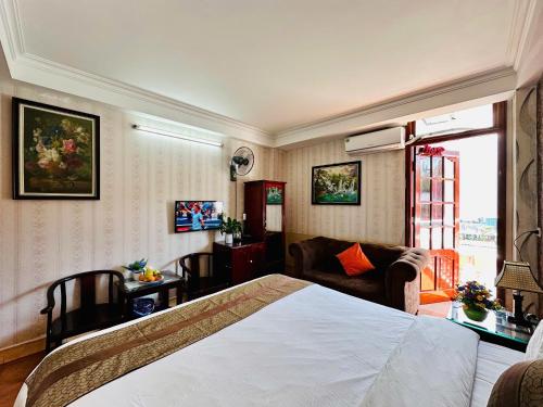 a bedroom with a bed and a living room at Hà Giang Hotel Sapa in Sa Pa