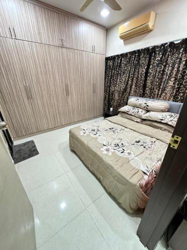 a bedroom with a large bed in a room at Harryna Homestay Damansara Damai in Petaling Jaya