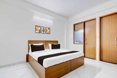 a bedroom with a large bed and wooden cabinets at Super Hotel O Divine Stay in Gurgaon