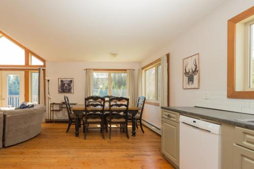 a kitchen and dining room with a table and chairs at Pet Friendly 3 Bdrm Home with Hot Tub by StayIn in Fernie