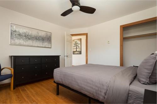 a bedroom with a bed and a ceiling fan at Pet Friendly 3 Bdrm Home with Hot Tub by StayIn in Fernie