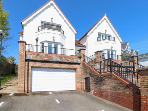 a large white house with a garage at Cambrie in Tenby