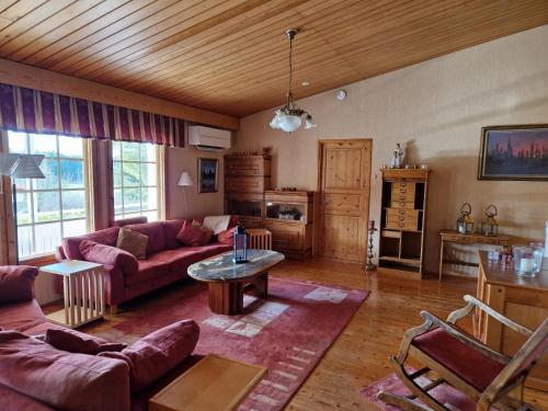a living room with a couch and a table at Villa Korpikallio in Naantali