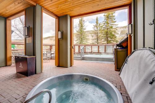 a large tub in a room with a balcony at Ski-InandOut Condo with Hot Tub Access in Keystone! in Keystone