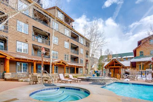 an apartment building with a swimming pool in front of a building at Ski-InandOut Condo with Hot Tub Access in Keystone! in Keystone