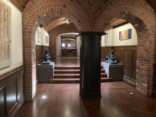 a brick hallway with a column in a building at New York On King in Perth
