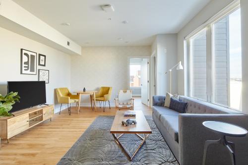 a living room with a couch and a table at The Frankford Fishtown in Philadelphia