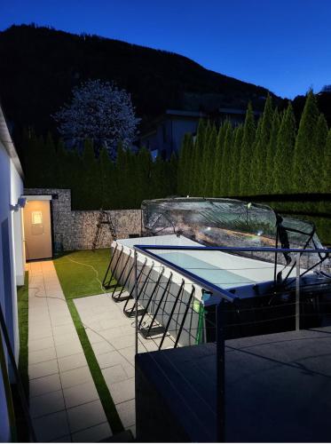 a ping pong table and chairs in a backyard at Gartenloft mit Pool in Imsterberg