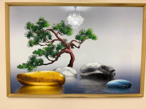 a painting of a tree and rocks in the water at UMMU ROHAT guest house in Samarkand