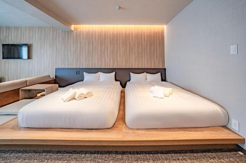 Ein Bett oder Betten in einem Zimmer der Unterkunft Apartment Hotel 11 Miyakojima