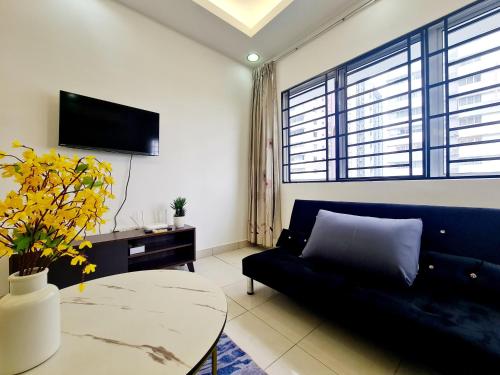 a living room with a blue couch and a table at Koi Puchong 3 Room IOI Puchong Bkt Jalil Pavilion Stadium Sunway Pyramid Lagoon Hospital in Puchong