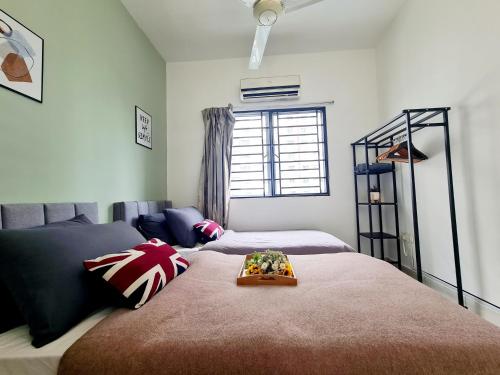a bedroom with two beds with a tray on the bed at Koi Puchong 3 Room IOI Puchong Bkt Jalil Pavilion Stadium Sunway Pyramid Lagoon Hospital in Puchong