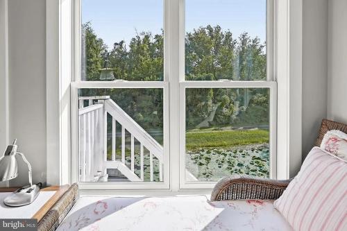 a living room with a large window and a couch at 1878 RiverRun B&B - Waterfront, Self-Serve Breakfast, WiFi, Trail and River access in Hancock