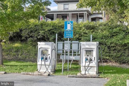 two old gas pumps on the side of a street at 1878 RiverRun B&B - Waterfront, Self-Serve Breakfast, WiFi, Trail and River access in Hancock