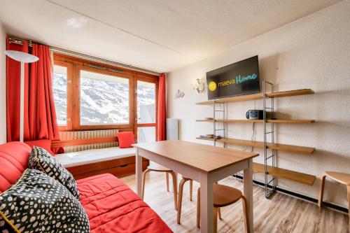un salon avec une table et un canapé dans l'établissement Résidence Le Tourmalet - maeva Home - Studio 6 personnes - Sélection MAE-0271, à La Mongie
