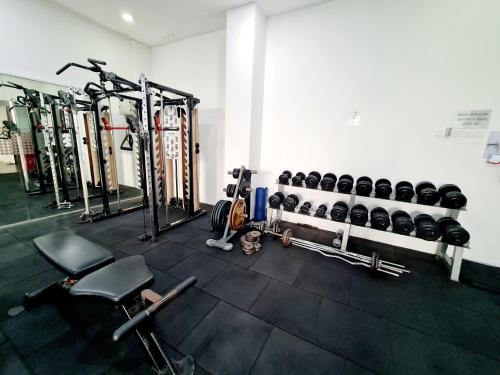 a gym with a bunch of equipment in a room at Koi Puchong 3 Room IOI Puchong Bkt Jalil Pavilion Stadium Sunway Pyramid Lagoon Hospital in Puchong