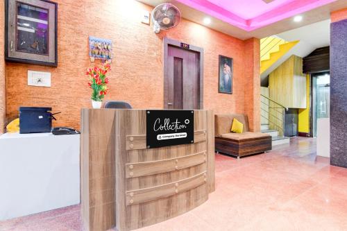 a lobby with a sign on a wooden door at Super Collection O Behala in Kolkata