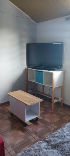 a living room with a flat screen tv and a coffee table at Filassa Home, Villa à la Rivière de l'Est, Sainte Rose in Le Petit Brûlé