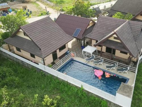 an aerial view of a house with a swimming pool at 2 Fully equipped Cottages w big Pool & Fishing in Bang Sare