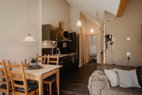 a kitchen and living room with a table and a couch at Kirnermarteshof in Oberried
