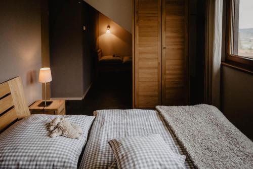 a bedroom with a bed with a teddy bear on it at Kirnermarteshof in Oberried