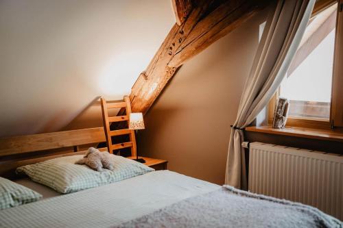a bedroom with a bed and a chair and a window at Kirnermarteshof in Oberried