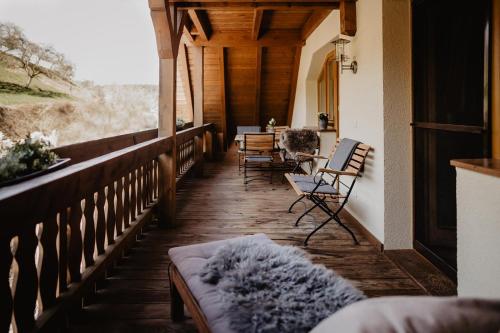 a porch of a house with chairs and a table at Kirnermarteshof in Oberried