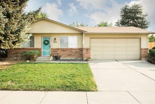 a house with a blue door and a garage at There's No Place Like Home in Garden City