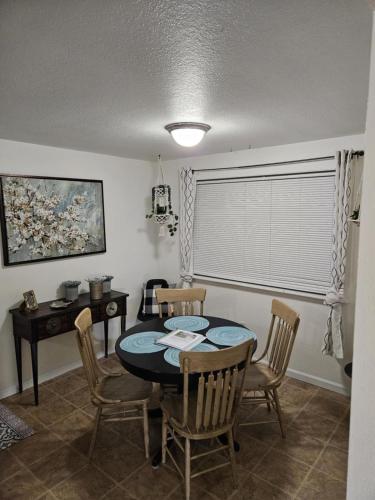 a dining room with a table and chairs at There's No Place Like Home in Garden City