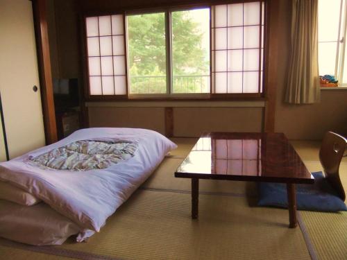 Кровать или кровати в номере Nishimiyasou