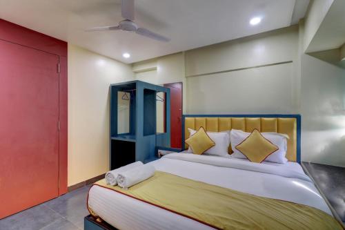 a bedroom with a bed and a blue cabinet at Hotel Platinum Inn in Navi Mumbai