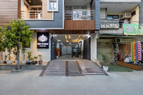 a building with a walkway in front of a store at Amaze Stays Noida Sector 70 in Noida