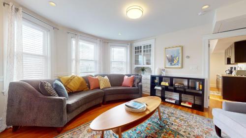 a living room with a couch and a table at Spacious 5br W Ac, Near Harvard & Davis Sq in Cambridge