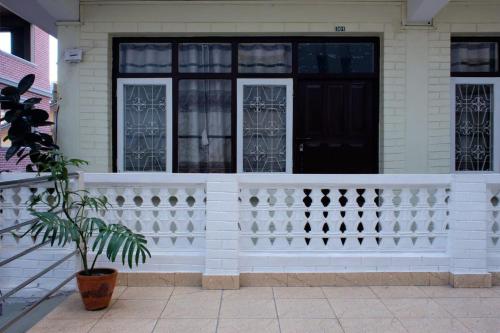 a white house with a white fence and a window at Hotel Shree Tara in Kathmandu