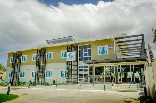 a large yellow building with blue windows at Twin Tides Panglao in Panglao