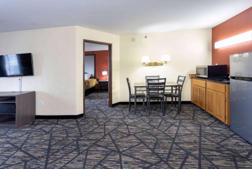 a room with a kitchen and a table and chairs at Super 8 by Wyndham Big Rapids in Big Rapids