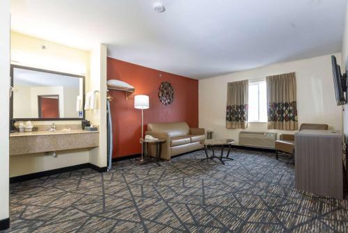 a hotel room with a sink and a mirror at Super 8 by Wyndham Big Rapids in Big Rapids