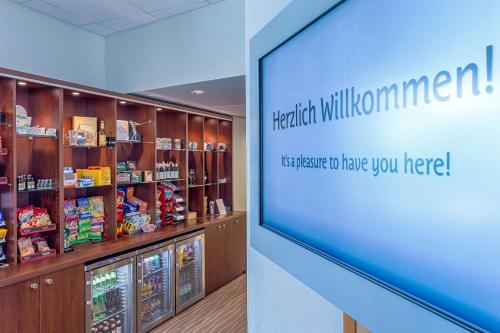 a large screen in a pharmacy with a pharmacyacistacistacistacistacistacistacist at Best Western Macrander Hotel Frankfurt/Kaiserlei in Offenbach