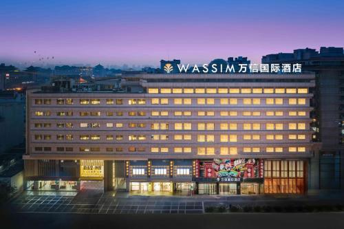 a building with a sign on the top of it at 西安钟鼓楼钟楼地铁站万信国际酒店 in Xi'an